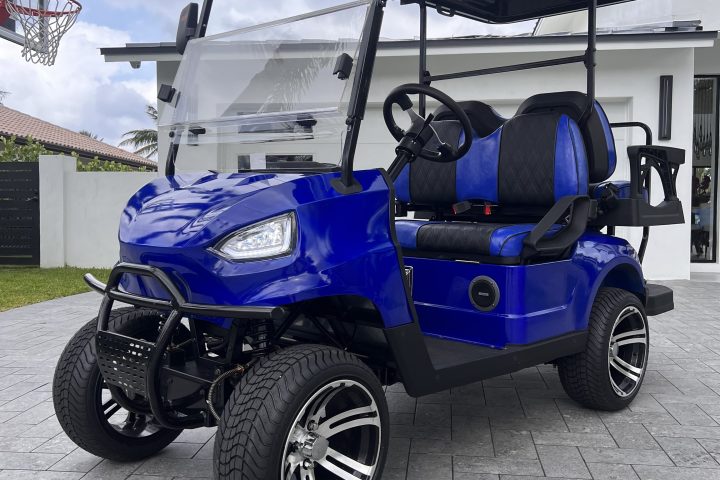 a blue golf cart parked on the side of a building