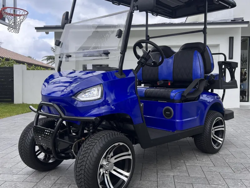 a blue golf cart parked on the side of a building