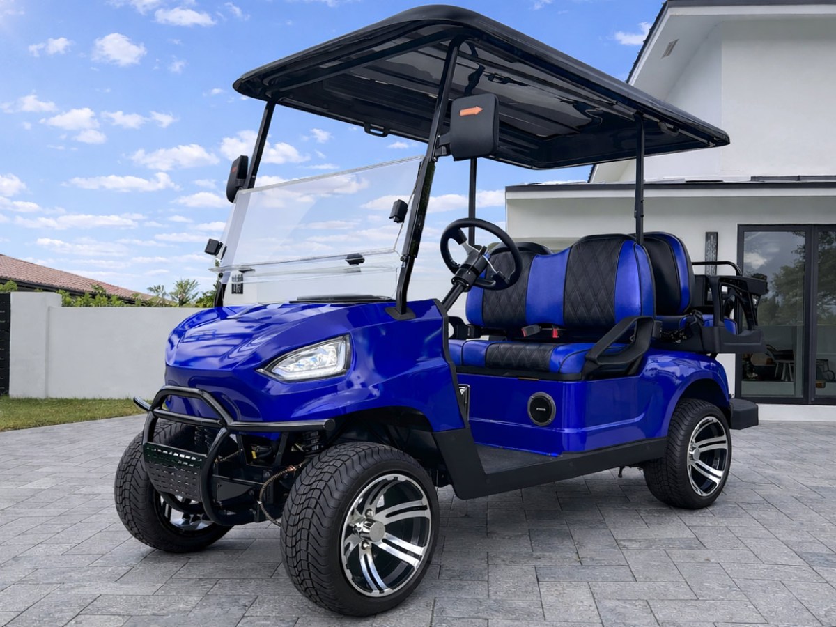 Blue, modern golf cart with black roof and seats parked on a driveway.